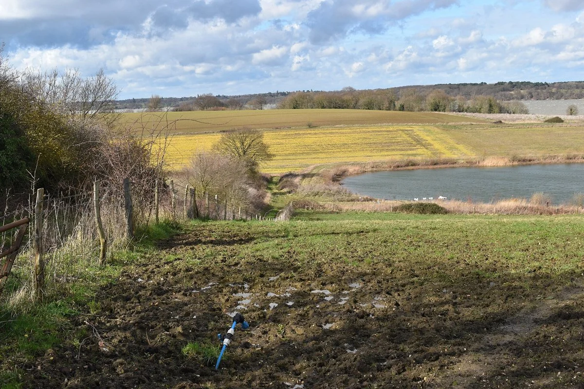 Farm irrigation reservoir below Charity Farm with an irrigation hydrant in the foreground