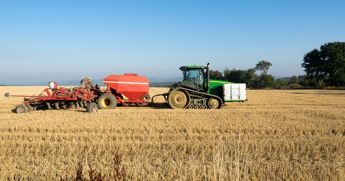 Stubble field with tractor and other farm machinery